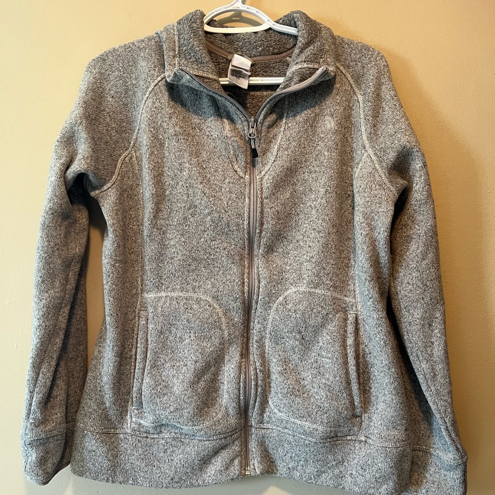 The North Face size M sweater zip up jacket. Two front slip pockets. Gray